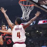 
              Toronto Raptors guard Dalano Banton (45) is fouled by Cleveland Cavaliers center Evan Mobley (4) as he attempts a layup during first-half NBA basketball game action in Toronto, Friday, Nov. 5, 2021. (Evan Buhler/The Canadian Press via AP)
            