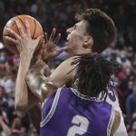 
              Gonzaga center Chet Holmgren, top, drives to the basket and is fouled by Tarleton State guard Freddy Hicks during the first half of an NCAA college basketball game, Monday, Nov. 29, 2021, in Spokane, Wash. (AP Photo/Young Kwak)
            