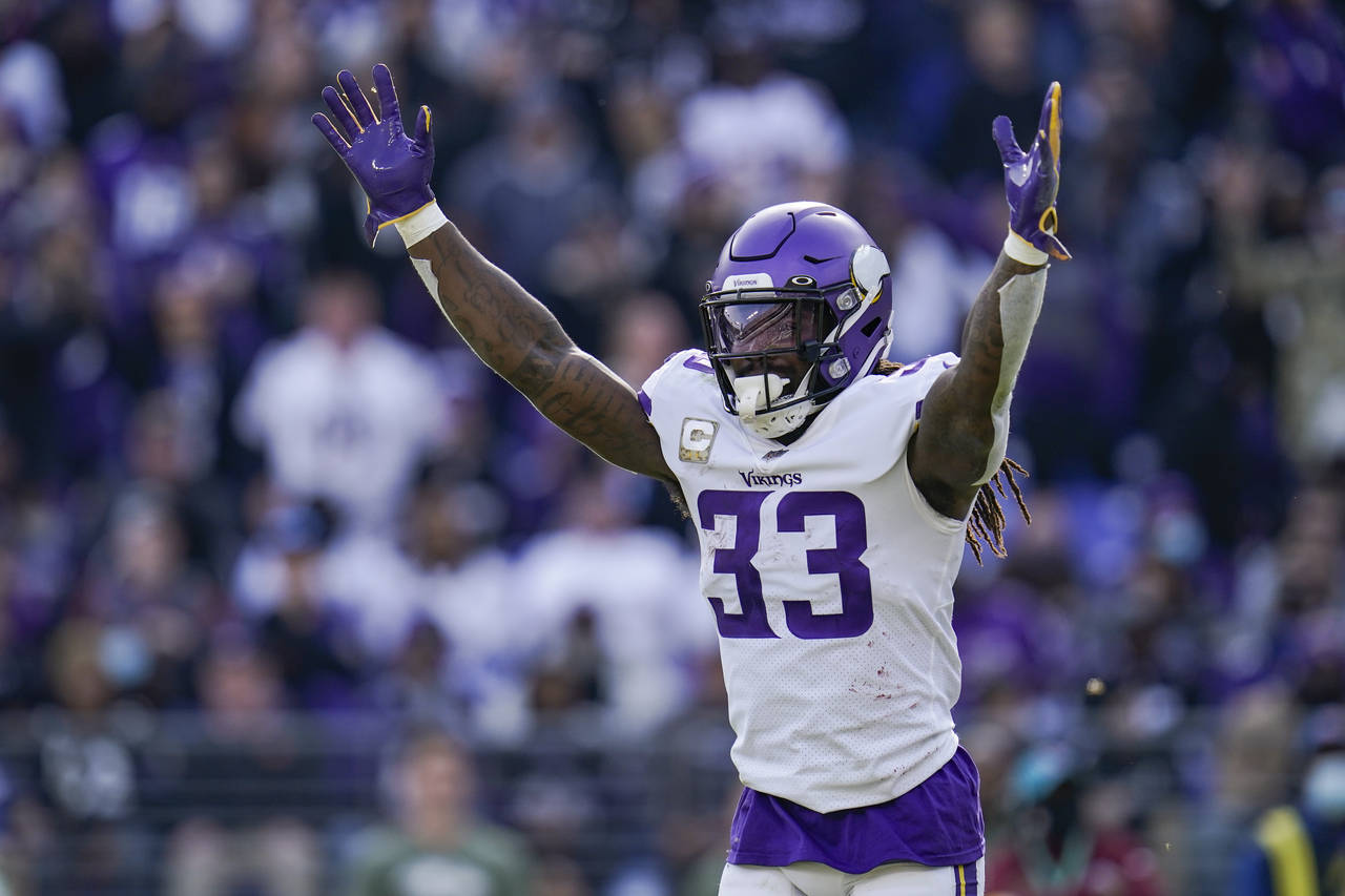 Minnesota Vikings running back Dalvin Cook celebrates a touchdown by quarterback Kirk Cousins durin...