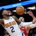 
              Phoenix Suns guard Elfrid Payton (2) has his shot blocked by New Orleans Pelicans center Jonas Valanciunas, right, during the first half of an NBA basketball game Tuesday, Nov. 2, 2021, in Phoenix. (AP Photo/Ross D. Franklin)
            