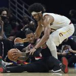 
              Portland Trail Blazers' Damian Lillard, bottom, looks to pass the ball as Cleveland Cavaliers' Jarrett Allen defends during the first half of an NBA basketball game Wednesday, Nov. 3, 2021, in Cleveland. (AP Photo/Tony Dejak)
            