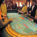 
              This June 23, 2021 photo shows a game of craps under way at Bally's casino in Atlantic City, N.J. Figures released Nov. 9, 2021 from the American Gaming Association show the nation's commercial casinos won nearly $14 billion in the third quarter of this year, marking the best three-month period in history for the industry, which is poised to have its best full year ever in 2021. (AP Photo/Wayne Parry)
            