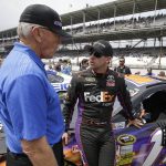 
              FILE - NASCAR team owner Joe Gibbs, left, talks with Denny Hamlin before the Brickyard 400 auto race at Indianapolis Motor Speedway in Indianapolis, July 27, 2014. Long recognized alongside Mark Martin as the greatest NASCAR driver to never win a championship, Hamlin has a fifth try Sunday to at long last grab that elusive Cup title.  (AP Photo/Darron Cummings, File)
            