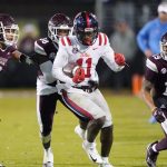 
              Mississippi wide receiver Dontario Drummond (11) runs past Mississippi State linebacker Aaron Brule (3) and safety Collin Duncan (19) after a pass reception during the first half of an NCAA college football game Thursday, Nov. 25, 2021, in Starkville, Miss. (AP Photo/Rogelio V. Solis)
            