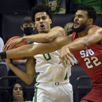 
              Oregon guard Will Richardson (0) hauls in a rebound while battling with SMU forward Isiah Jasey (22) during the first half of an NCAA college basketball game Friday, Nov. 12, 2021, in Eugene, Ore. (AP Photo/Andy Nelson)
            