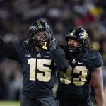 
              Purdue defensive end DaMarcus Mitchell (15) and defensive tackle Prince Boyd Jr. (93) celebrate as they defeat Michigan State in an NCAA college football game in West Lafayette, Ind., Saturday, Nov. 6, 2021. (AP Photo/Michael Conroy)
            