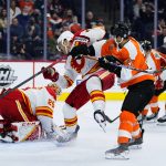 
              Philadelphia Flyers' Scott Laughton (21) collides with Calgary Flames' Erik Gudbranson (44) during the second period of an NHL hockey game, Tuesday, Nov. 16, 2021, in Philadelphia. (AP Photo/Matt Slocum)
            