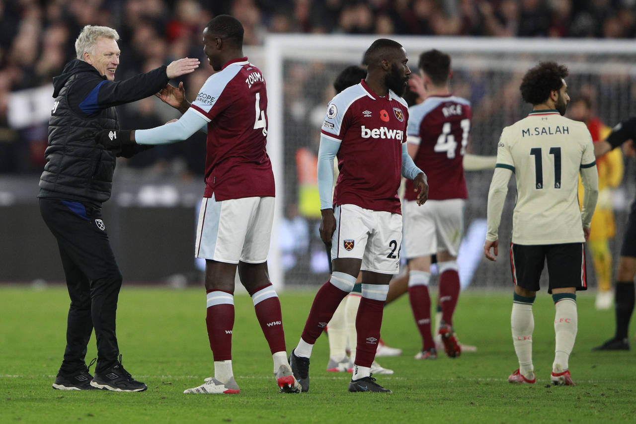 West Ham's manager David Moyes hugs players at the end of the English Premier League soccer match b...