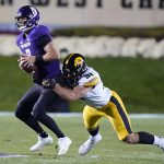
              Northwestern quarterback Andrew Marty, left, is called for intentional grounding against Iowa defensive lineman Lukas Van Ness during the first half of an NCAA college football game in Evanston, Ill., Saturday, Nov. 6, 2021. (AP Photo/Nam Y. Huh)
            