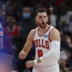 
              Chicago Bulls' Zach LaVine (8) celebrates after dunking while New York Knicks' Julius Randle (30) looks on during the first half of a NBA basketball game Sunday, Nov. 21, 2021 in Chicago. (AP Photo/Paul Beaty)
            