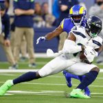INGLEWOOD, CALIFORNIA - DECEMBER 21: DK Metcalf #14 of the Seattle Seahawks catches the ball as David Long #22 of the Los Angeles Rams defends in the first quarter of the game at SoFi Stadium on December 21, 2021 in Inglewood, California. (Photo by Ronald Martinez/Getty Images)