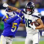 INGLEWOOD, CALIFORNIA - DECEMBER 21: Freddie Swain #18 of the Seattle Seahawks stiffarms Jalen Ramsey #5 of the Los Angeles Rams in the third quarter of the game at SoFi Stadium on December 21, 2021 in Inglewood, California. (Photo by Sean M. Haffey/Getty Images)
