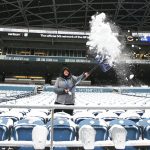SEATTLE, WASHINGTON - DECEMBER 26: A field employee shovels snow off seats at Lumen Field before the game between the Seattle Seahawks and Chicago Bears on December 26, 2021 in Seattle, Washington. (Photo by Abbie Parr/Getty Images)