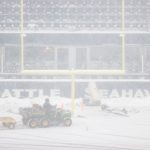 SEATTLE, WASHINGTON - DECEMBER 26: Field staff work on clearing the snow at Lumen Field before the game between the Seattle Seahawks and Chicago Bears on December 26, 2021 in Seattle, Washington. (Photo by Steph Chambers/Getty Images)