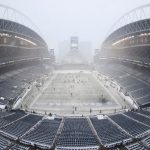 SEATTLE, WASHINGTON - DECEMBER 26: Field staff work on clearing the snow at Lumen Field before the game between the Seattle Seahawks and Chicago Bears on December 26, 2021 in Seattle, Washington. (Photo by Steph Chambers/Getty Images)