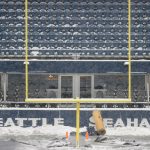 SEATTLE, WASHINGTON - DECEMBER 26: Field staff work on clearing the snow at Lumen Field before the game between the Seattle Seahawks and Chicago Bears on December 26, 2021 in Seattle, Washington. (Photo by Steph Chambers/Getty Images)