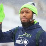 SEATTLE, WASHINGTON - DECEMBER 26: Carlos Dunlap #8 of the Seattle Seahawks warms-up before the game against the Chicago Bears at Lumen Field on December 26, 2021 in Seattle, Washington. (Photo by Abbie Parr/Getty Images)