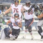 SEATTLE, WASHINGTON - DECEMBER 26: David Montgomery #32 of the Chicago Bears runs the ball and is tackled during the first quarter against the Seattle Seahawks at Lumen Field on December 26, 2021 in Seattle, Washington. (Photo by Abbie Parr/Getty Images)