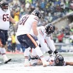 SEATTLE, WASHINGTON - DECEMBER 26: David Montgomery #32 of the Chicago Bears celebrates with teammates after scoring a touchdown during the second quarter against the Seattle Seahawks at Lumen Field on December 26, 2021 in Seattle, Washington. (Photo by Steph Chambers/Getty Images)