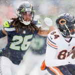 SEATTLE, WASHINGTON - DECEMBER 26: Marquise Goodwin #84 of the Chicago Bears catches the ball as Sidney Jones #23 of the Seattle Seahawks defends during the second quarter at Lumen Field on December 26, 2021 in Seattle, Washington. (Photo by Steph Chambers/Getty Images)