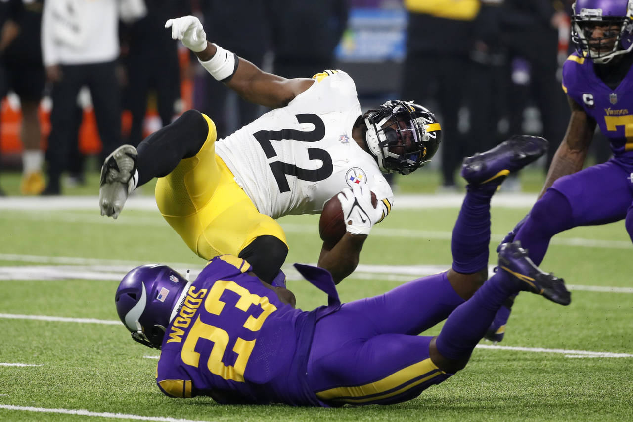 Pittsburgh Steelers running back Najee Harris (22) is tackled by Minnesota Vikings free safety Xavi...