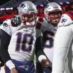 
              New England Patriots quarterback Mac Jones (10) and David Andrews (60) walk off the field after getting a win over the Buffalo Bills in an NFL football game in Orchard Park, N.Y., Monday, Dec. 6, 2021. (AP Photo/Joshua Bessex )
            
