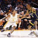 
              Tennessee guard Zakai Zeigler (5) drives against UNC-Greensboro guard Keyshaun Langley (0) during an NCAA college basketball game Saturday, Dec. 11, 2021, in Knoxville, Tenn. Tennessee won 76-36. (AP Photo/Wade Payne)
            