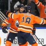 
              Edmonton Oilers' Darnell Nurse (25) and Zach Hyman (18) celebrate a goal against the Los Angeles Kings during the second period of an NHL hockey game in Edmonton, Alberta, Sunday, Dec. 5, 2021. (Jason Franson/The Canadian Press via AP)
            