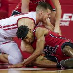 
              Wisconsin's Chris Vogt, left, and Illinois State's Kendall Lewis (22) scrap for the ball during the first half of an NCAA college basketball game Wednesday, Dec. 29, 2021, in Madison, Wis. (AP Photo/Andy Manis)
            