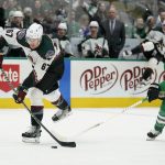 
              Arizona Coyotes left wing Lawson Crouse (67) shoots as Dallas Stars center Joe Pavelski (16) defends in the second period of an NHL hockey game in Dallas, Monday, Dec. 6, 2021. (AP Photo/Tony Gutierrez)
            