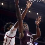
              Eastern Kentucky forward Devontae Blanton (14) goes to basket while defended by Southern California forward Max Agbonkpolo (23) during the second half of an NCAA college basketball game Tuesday, Dec. 7, 2021, in Los Angeles. USC won 80-68. (AP Photo/Ringo H.W. Chiu)
            