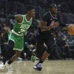 
              Boston Celtics guard Dennis Schroder (71) defends agains tLos Angeles Clippers guard Reggie Jackson (1) during the first half of an NBA basketball game in Los Angeles, Wednesday, Dec. 8, 2021. (AP Photo/Ashley Landis)
            