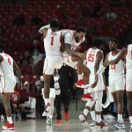 
              Houston guards Jamal Shead (1) and Kyler Edwards react to Shead's dunk against Bryant during the first half of an NCAA college basketball game Friday, Dec. 3, 2021, in Houston. (AP Photo/Justin Rex)
            
