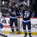
              Winnipeg Jets' Pierre-Luc Dubois (80) celebrates his goal against the Toronto Maple Leafs with Blake Wheeler (26) during the first period of an NHL hockey game, Sunday, Dec. 5, 2021, in Winnipeg, Manitoba. (Fred Greenslade/The Canadian Press via AP)
            