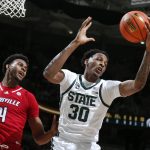 
              Michigan State's Marcus Bingham Jr., right, pulls down a rebound next to Louisville's Roosevelt Wheeler (4) during the first half of an NCAA college basketball game Wednesday, Dec. 1, 2021, in East Lansing, Mich. (AP Photo/Al Goldis)
            