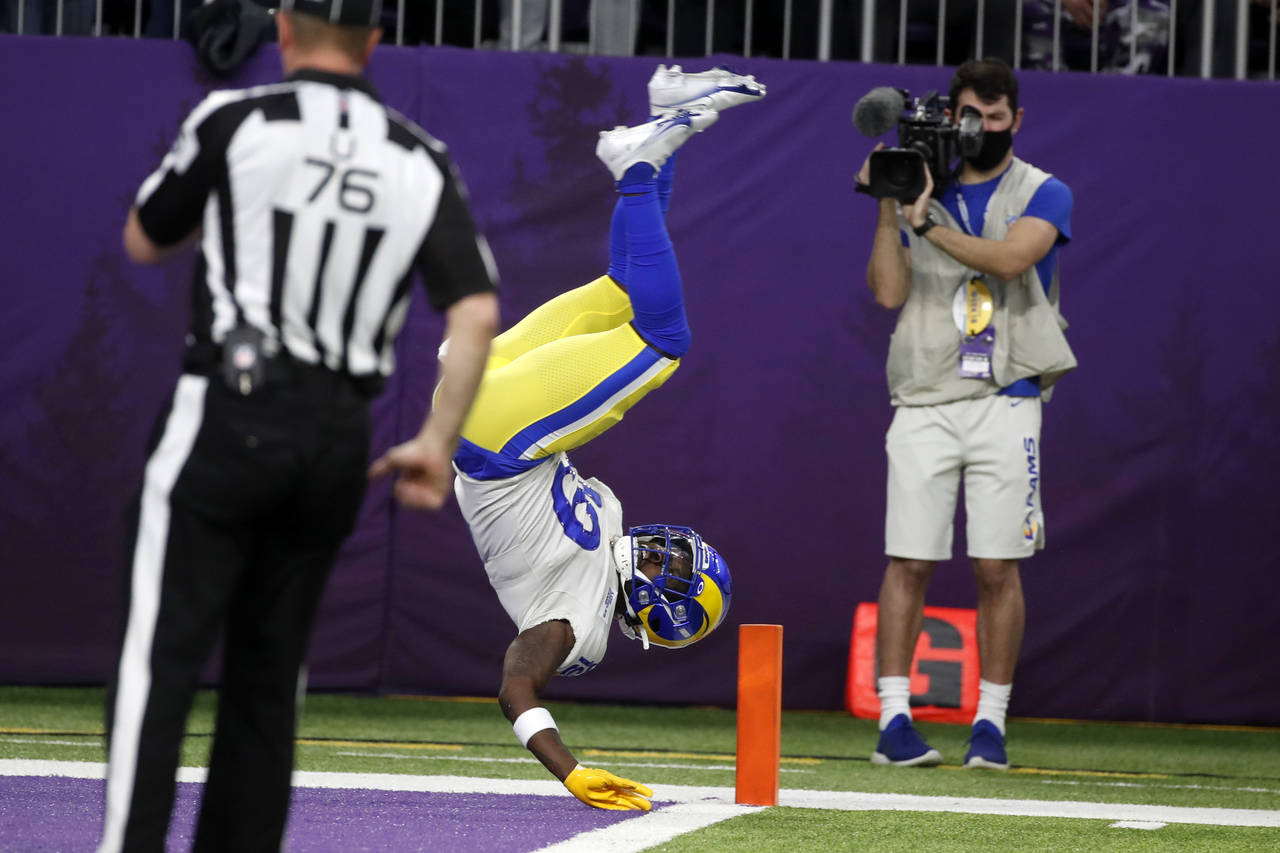 Los Angeles Rams' Brandon Powell flips into the end zone during a 61-yard punt return for a touchdo...