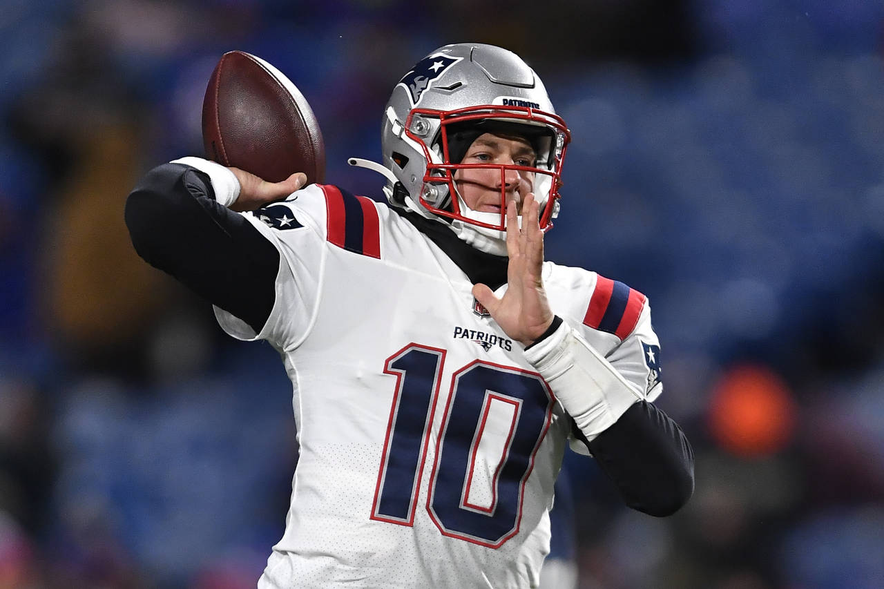 New England Patriots quarterback Mac Jones (10) looks to throw a pass during the first half of an N...