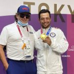 
              FILE - Xander Schauffele, of the United States, poses with his gold medal in the men's golf event, next to his father, Stefan, at the 2020 Summer Olympics on Aug. 1, 2021, in Kawagoe, Japan. The father wore his son's Olympic credential because Xander Schauffele is notorious for losing special mementos. (AP Photo/Doug Ferguson, File)
            
