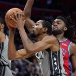 
              Brooklyn Nets forward Kevin Durant (7) attempts a layup as Detroit Pistons center Isaiah Stewart defends during the second half of an NBA basketball game, Sunday, Dec. 12, 2021, in Detroit. (AP Photo/Carlos Osorio)
            