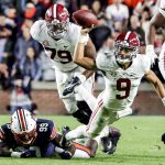 
              Alabama quarterback Bryce Young (9) is tacked as he tries to pass by Auburn defensive end T.D. Moultry (99) during the second half of an NCAA college football game Saturday, Nov. 27, 2021, in Auburn, Ala. (AP Photo/Butch Dill)
            