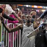 
              Brooklyn Nets forward Kevin Durant (7) makes his way past fans as he walks to the locker room after the Nets defeated the Atlanta Hawks in an NBA basketball game Friday, Dec. 10, 2021, in Atlanta. (AP Photo/John Bazemore)
            