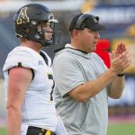 
              Appalachian State head coach Shawn Clark, right, claps next to quarterback Chase Brice (7) after an extra point during the first half of the Sun Belt Conference championship NCAA college football game against Louisiana-Lafayette in Lafayette, La., Saturday, Dec. 4, 2021. (AP Photo/Matthew Hinton)
            