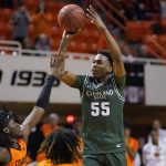 
              Cleveland State guard D'Moi Hodge (55) shoots over Oklahoma State guard Isaac Likekele, left, in overtime of an NCAA college basketball game Monday, Dec. 13, 2021, in Stillwater, Okla. (AP Photo/Sue Ogrocki)
            