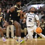 
              Butler guard Aaron Thompson (2) drives past Purdue forward Trevion Williams (50) during the first half of an NCAA college basketball game, Saturday, Dec. 18, 2021, in Indianapolis. (AP Photo/AJ Mast)
            