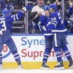 
              Toronto Maple Leafs' David Kampf, center, celebrates his goal against the Chicago Blackhawks with teammates Wayne Simmonds, right, and Kyle Clifford during third-period NHL hockey game action in Toronto, Saturday, Dec. 11, 2021. (Chris Young/The Canadian Press via AP)
            