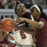 
              North Carolina State forward Jada Boyd (5) drives to the basket while Elon guard Kayla Liles (2) defends during the first half of an NCAA college basketball game in Raleigh, N.C., Sunday, Dec. 5, 2021. (AP Photo/Gerry Broome)
            