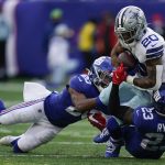 
              Dallas Cowboys running back Tony Pollard (20) is tackled by New York Giants cornerback Julian Love (20) and safety Logan Ryan (23) during the second quarter of an NFL football game, Sunday, Dec. 19, 2021, in East Rutherford, N.J. (AP Photo/Seth Wenig)
            