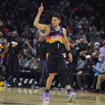 
              Phoenix Suns guard Devin Booker (1) reacts after scoring against the Oklahoma City Thunder during the second half of an NBA basketball game, Thursday, Dec. 23, 2021, in Phoenix. The Suns won 113-101. (AP Photo/Rick Scuteri)
            
