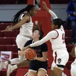 
              North Carolina State forward Kayla Jones, left, and center Camille Hobby (41) defend against Saint Mary's forward Amy West, center, during the second half of an NCAA college basketball game in Raleigh, N.C., Sunday, Dec. 12, 2021. (AP Photo/Gerry Broome)
            