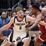 
              Gonzaga's Drew Timme (2) tries to get past Alabama's Noah Gurley during the second half of an NCAA college basketball game Saturday, Dec. 4, 2021, in Seattle. Alabama won 91-82. (AP Photo/Elaine Thompson)
            